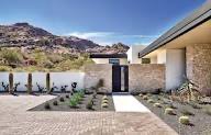 Modern desert home entrance with paver driveway and minimalist landscaping — Phoenix AZ